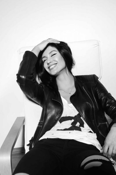 stylish smiling sexy brunette sitting on the chair and laughing